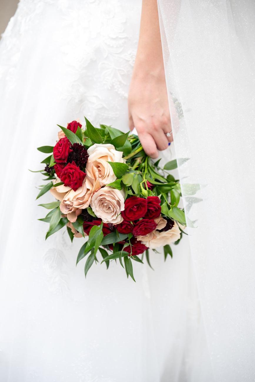 Bouquet of red roses laid on white silk