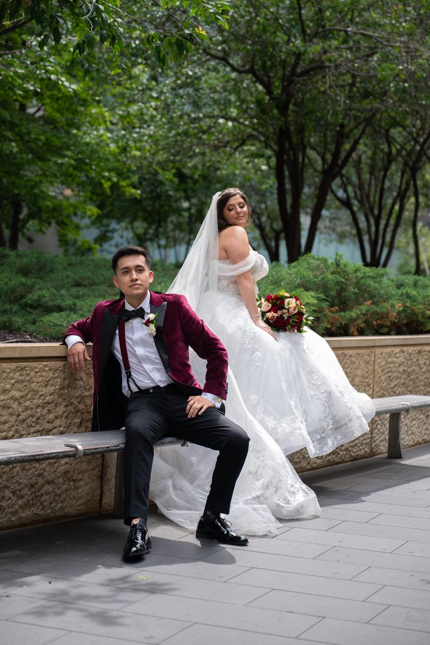 A groom seated with his bride beside him, both smiling