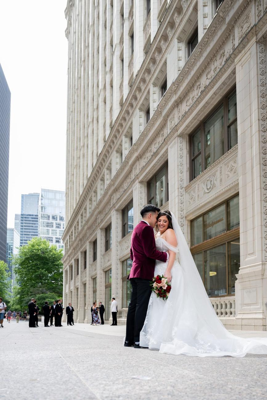 A couple embracing on a downtown Chicago street beside historic architecture