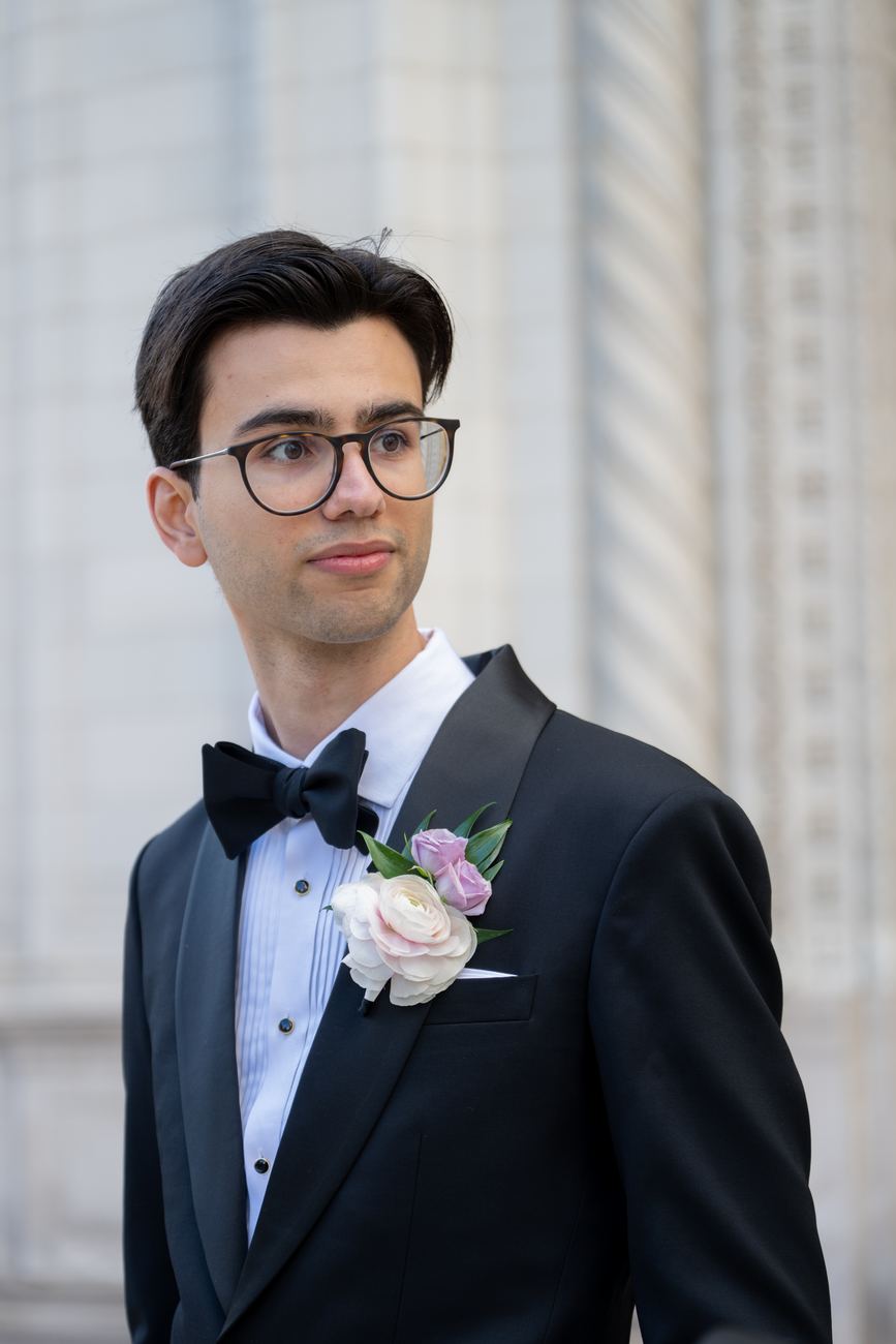A groom in a tuxedo and boutonniere, portrait
