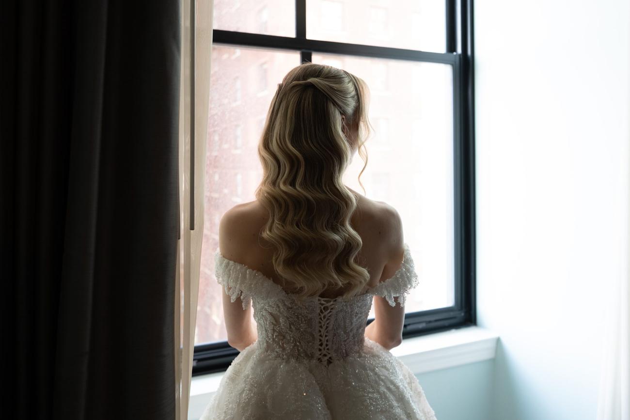 Bride's silhouette against a tall window