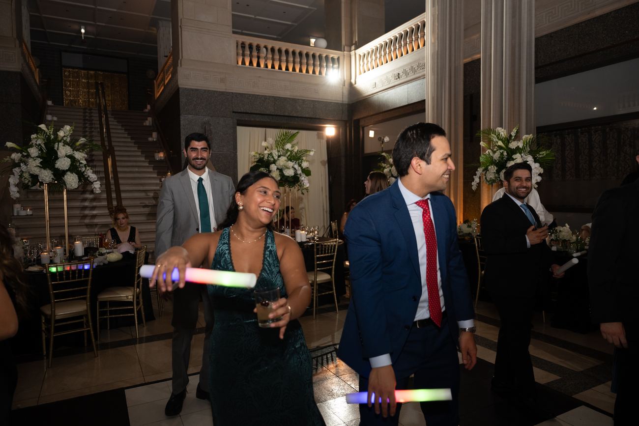 Guests dancing with glow sticks on the dance floor