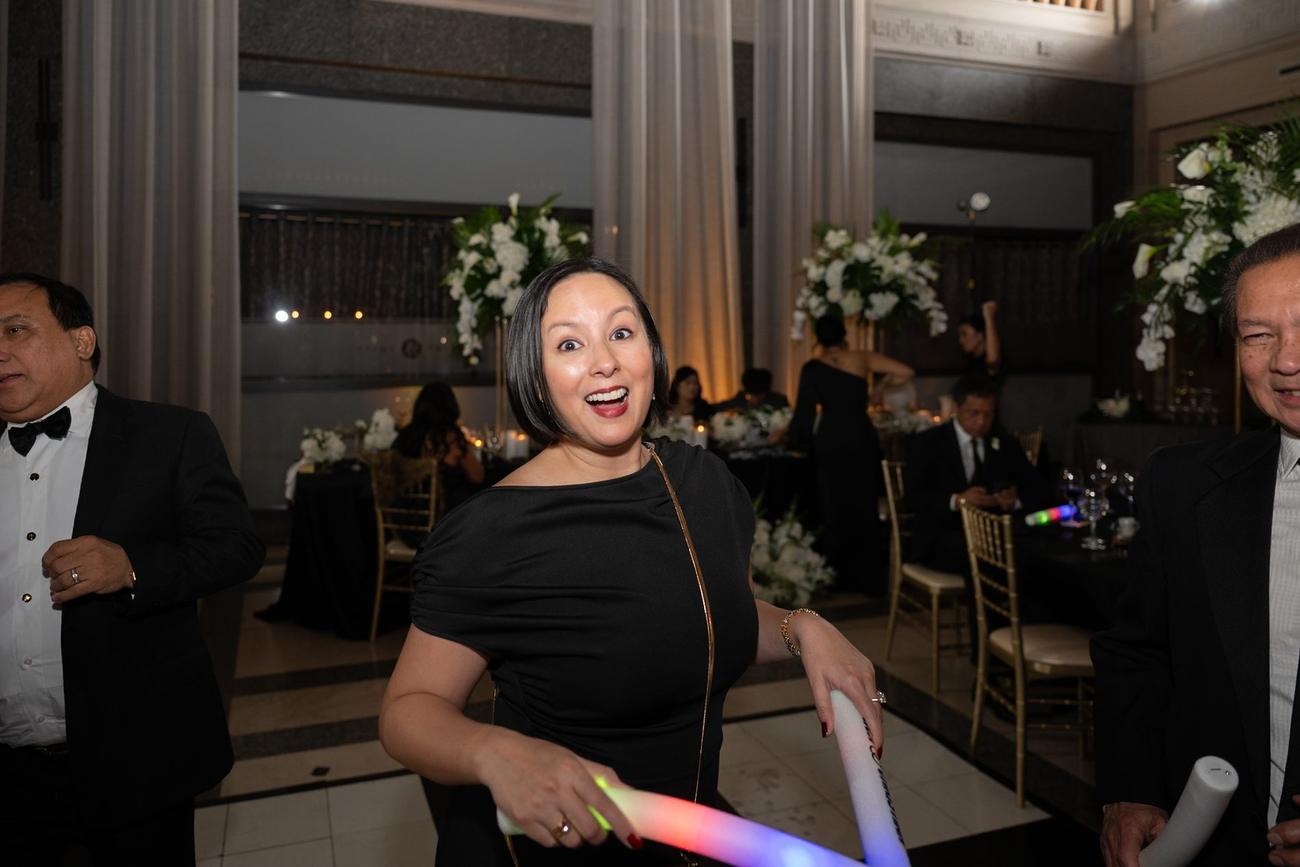 Guests dancing with glow sticks late in the reception