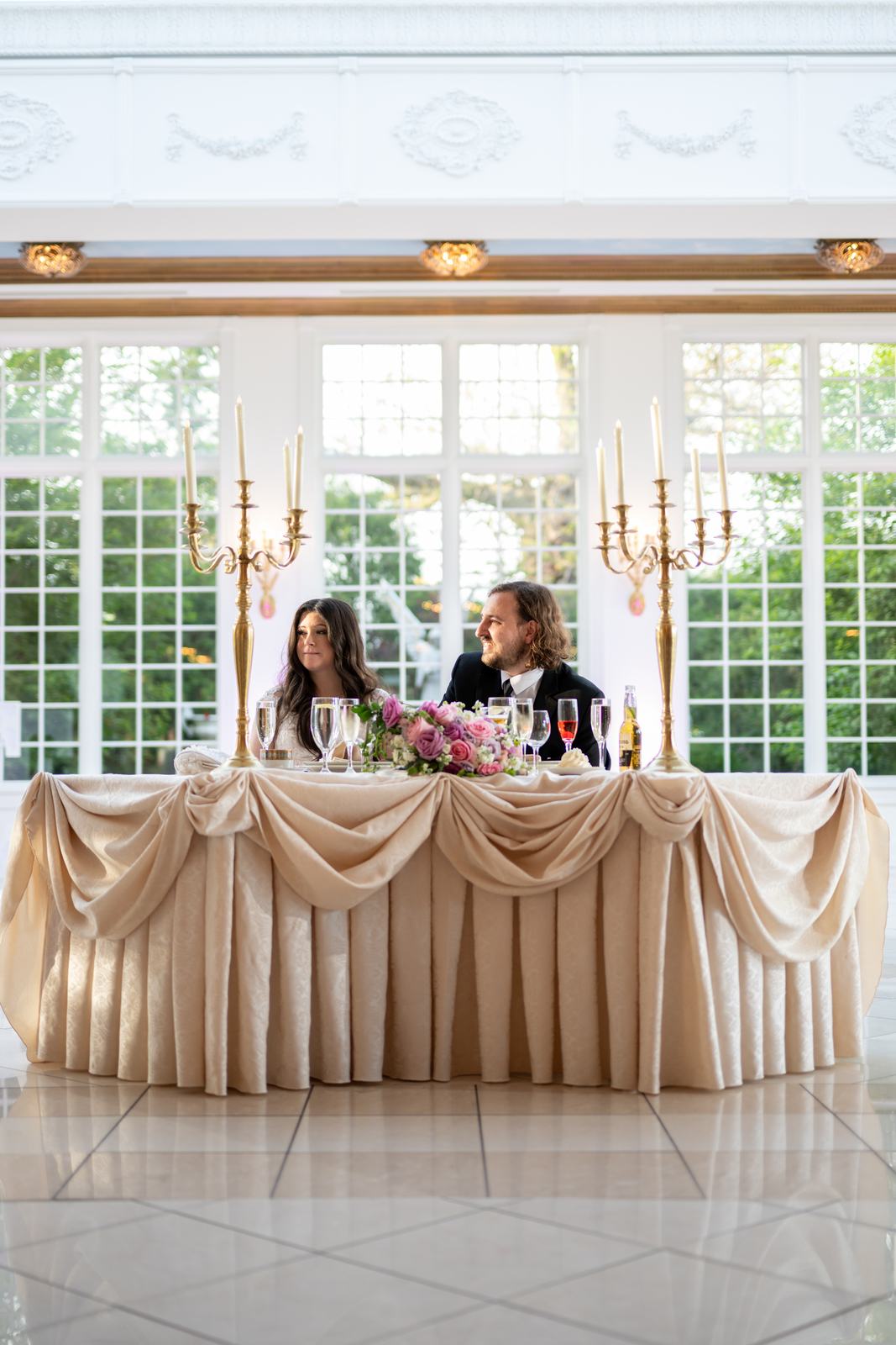 A couple at the signing table in a sunlit conservatory
