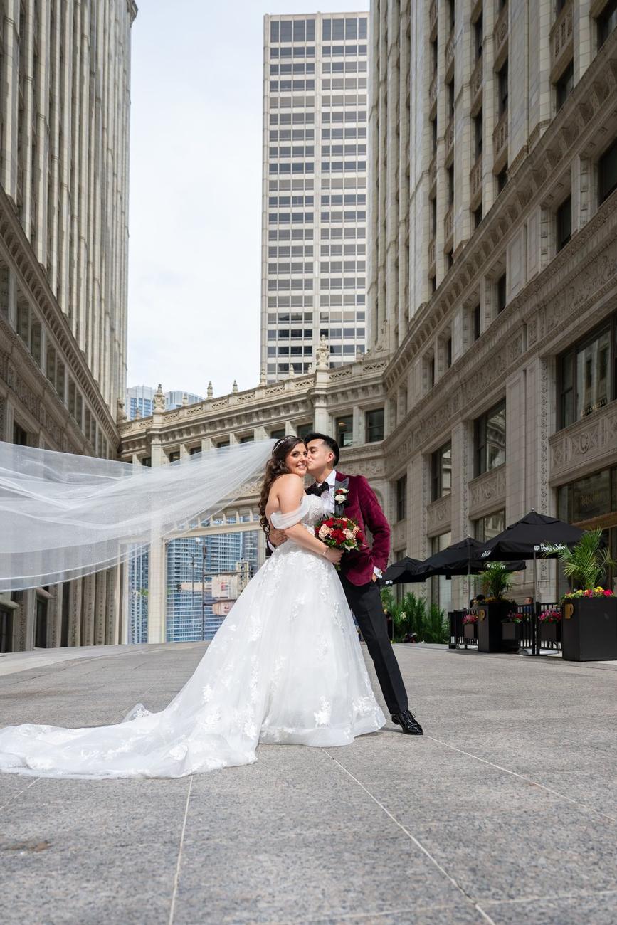 Bride's veil caught by the wind among Chicago skyscrapers