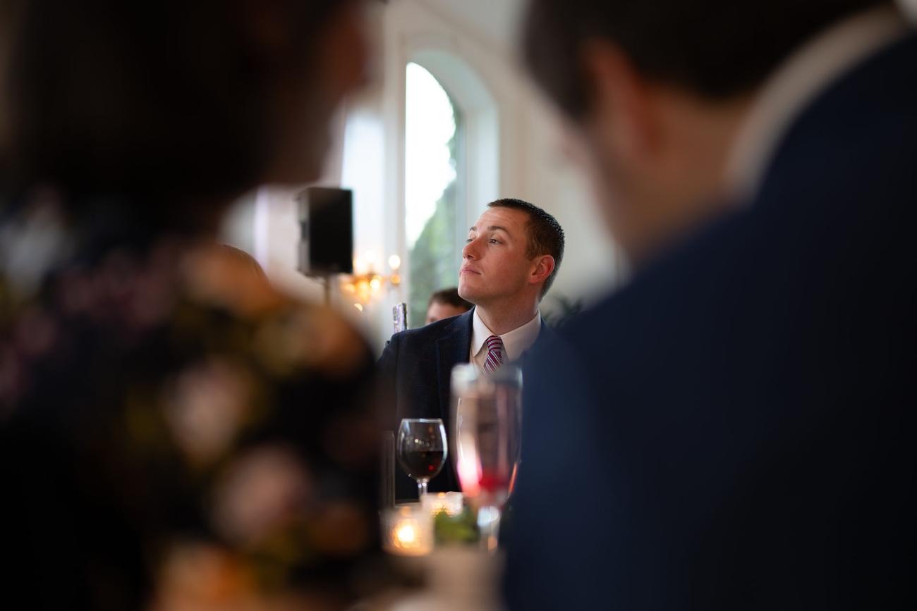 Guests laughing during a candid reception toast