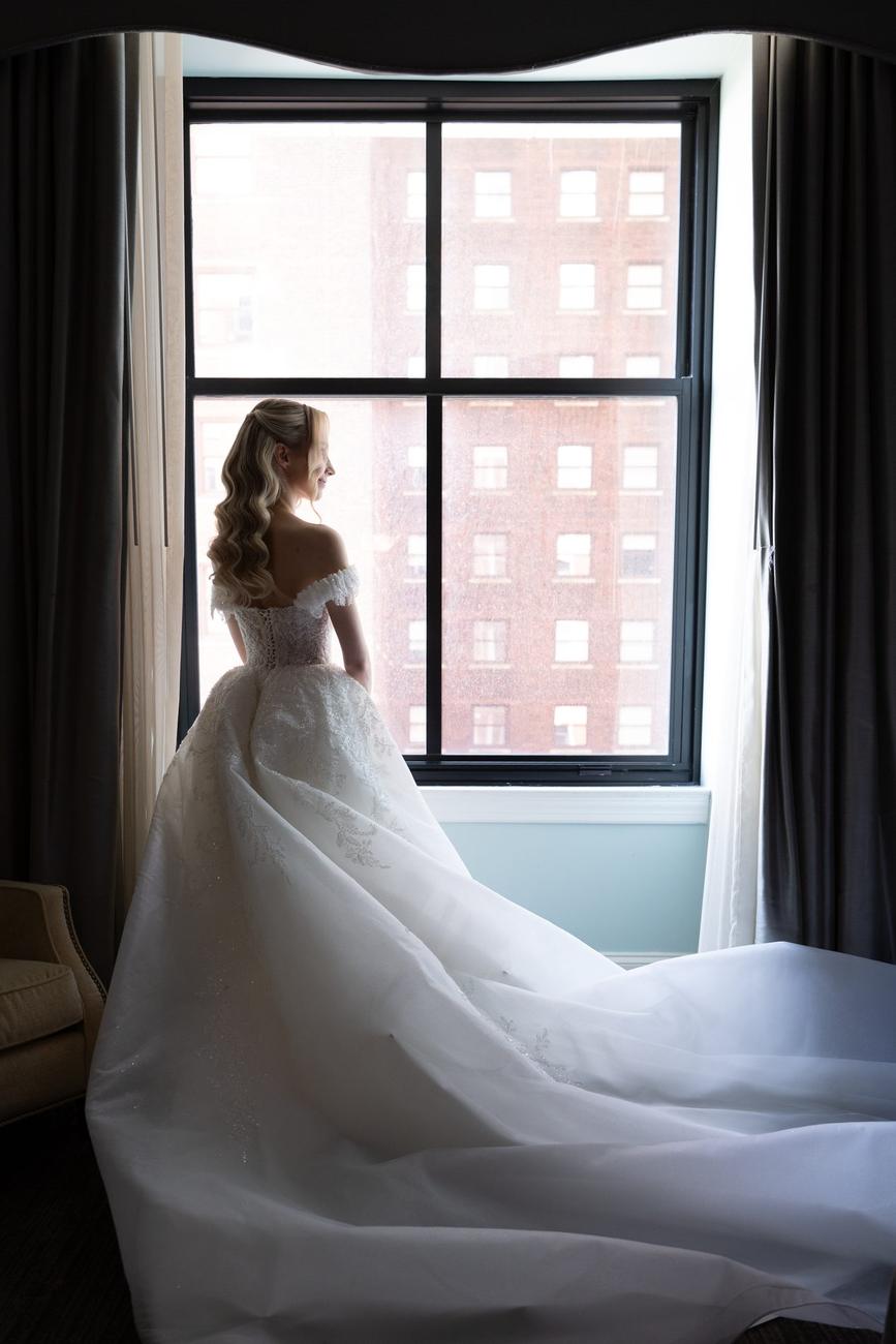Bride's silhouette against a bright window, veil catching the light