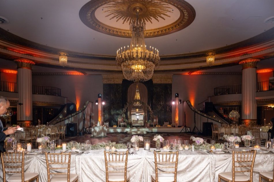 A domed reception ballroom glowing beneath a gilded ceiling