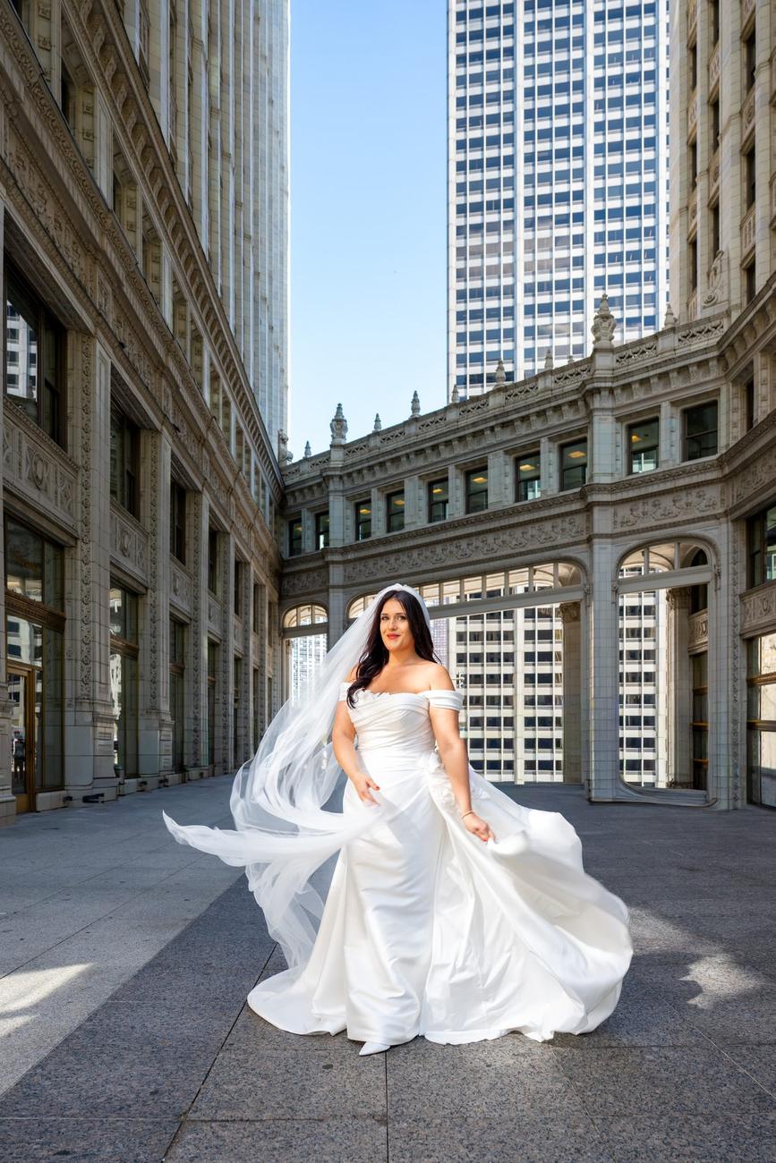 Bride in a flowing gown among Chicago's downtown architecture